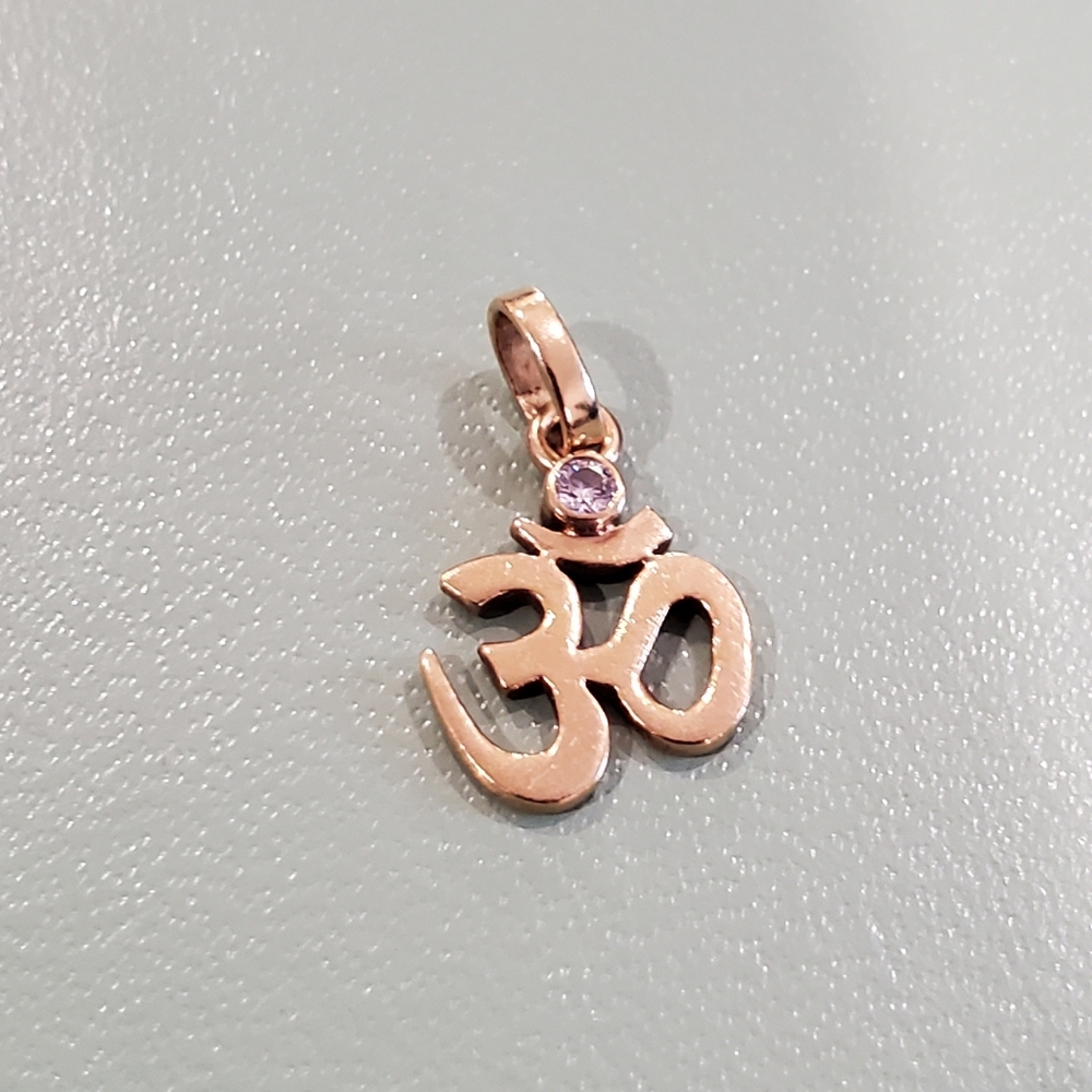 Authentic 18k Gold Ohm pendant with single small diamond